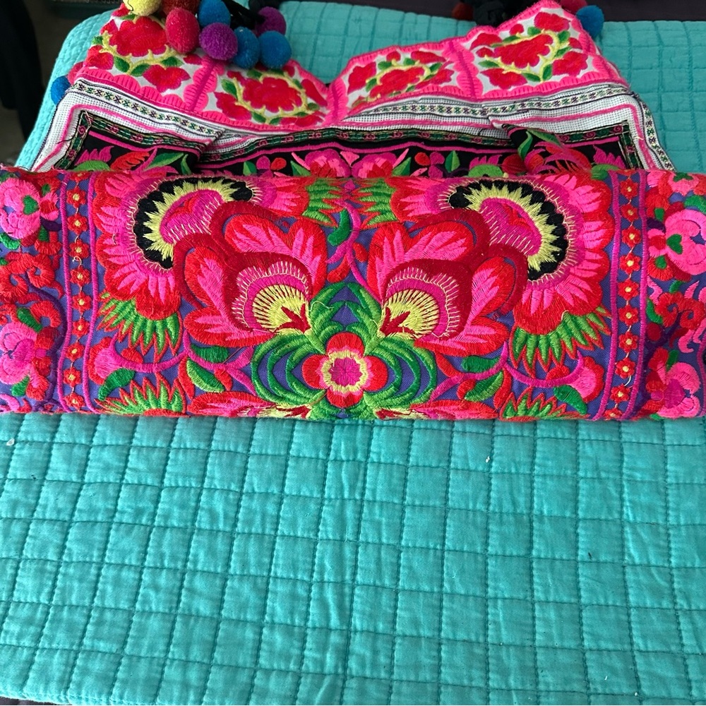 Vibrant Floral Embroidered Textile with Pom Poms